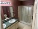Bathroom featuring dual sinks, a spacious mirror, and a walk-in shower, combining functionality and comfort at 1148 Nanwich Ct, Indianapolis, IN 46217