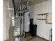 Image shows the utility room with the water heater and HVAC system and shelves for storage at 1148 Nanwich Ct, Indianapolis, IN 46217