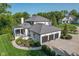 Aerial view of home showing landscaping, covered porch, three-car garage, and large driveway at 11620 Willow Springs Dr, Zionsville, IN 46077
