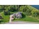 Expansive aerial view of a luxurious home surrounded by lush greenery and mature trees at 11620 Willow Springs Dr, Zionsville, IN 46077