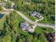 This aerial view shows the home's manicured lawns, mature trees, and ample space between neighboring properties at 11620 Willow Springs Dr, Zionsville, IN 46077