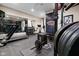 Well-equipped home gym with a treadmill, free weights, and a mirrored wall at 11620 Willow Springs Dr, Zionsville, IN 46077