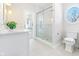 Serene bathroom featuring a glass-enclosed shower, white tile, and round window at 11620 Willow Springs Dr, Zionsville, IN 46077
