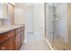 Bright bathroom featuring a glass-enclosed shower, marble countertops, and tiled floors, offering a clean, modern aesthetic at 11620 Willow Springs Dr, Zionsville, IN 46077