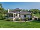 Well-manicured lawn and landscaping that accentuates the rear exterior elevation of the home at 11620 Willow Springs Dr, Zionsville, IN 46077