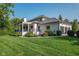 Stately home features a three car garage, covered porch, and manicured landscaping at 11620 Willow Springs Dr, Zionsville, IN 46077