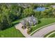 Stunning home featuring mature landscaping, a circular driveway, and a charming front porch at 11620 Willow Springs Dr, Zionsville, IN 46077