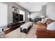 Stylish living room with modern decor, a comfortable leather couch, and wood floors at 11620 Willow Springs Dr, Zionsville, IN 46077