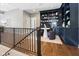 Cozy loft area with custom built-in shelving, a small table, and comfortable seating, perfect for relaxation and reading at 11620 Willow Springs Dr, Zionsville, IN 46077