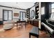 Stylish home office featuring dark built-ins, hardwood floors, and a unique light fixture at 11620 Willow Springs Dr, Zionsville, IN 46077