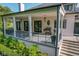 Covered porch with black railings features outdoor furniture, lighting, and stairs at 11620 Willow Springs Dr, Zionsville, IN 46077