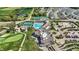 A top-down view of tennis courts, a pool, and the community center showcasing recreational facilities and houses at 1225 Stonehaven Dr, Westfield, IN 46074