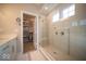 Bright bathroom showcases a tiled walk-in shower, window, and a walk-in closet at 1225 Stonehaven Dr, Westfield, IN 46074