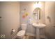 Charming powder room featuring pedestal sink, decorative flowers and stylish decor at 1225 Stonehaven Dr, Westfield, IN 46074
