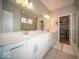 Bright bathroom features a double sink vanity, quartz countertop, and a walk-in closet at 1225 Stonehaven Dr, Westfield, IN 46074