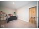 Bedroom with carpet flooring, neutral walls, and a view into the ensuite at 1225 Stonehaven Dr, Westfield, IN 46074