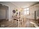 Elegant dining room with a large table and chandelier, adjacent to the kitchen at 1225 Stonehaven Dr, Westfield, IN 46074