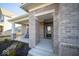 A welcoming home entrance with a covered porch, stylish brickwork, and a cozy seating area for guests at 1225 Stonehaven Dr, Westfield, IN 46074