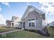 A quaint home with landscaped yard, brick pathway, and covered porch with seating for relaxing outdoors at 1225 Stonehaven Dr, Westfield, IN 46074