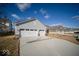 Attached three-car garage with ample driveway space in a well-maintained community at 1225 Stonehaven Dr, Westfield, IN 46074