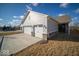 Spacious three-car garage with stylish doors, large driveway, and well-manicured lawn at 1225 Stonehaven Dr, Westfield, IN 46074