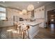 Bright kitchen featuring a large island with bar seating and modern lighting fixtures at 1225 Stonehaven Dr, Westfield, IN 46074