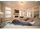 Spacious living room with a fireplace, large windows, and hardwood flooring at 1225 Stonehaven Dr, Westfield, IN 46074