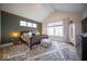 Spacious main bedroom featuring wood accent wall, a high ceiling, and stylish rug, creating a relaxing retreat at 1225 Stonehaven Dr, Westfield, IN 46074