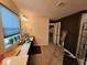 Well-lit bathroom with a double vanity, tiled floor, and a glimpse into the connected bedroom at 12889 Girvan Way, Fishers, IN 46037