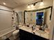 Bathroom with double sinks, a large mirror and a shower with a shower curtain at 12889 Girvan Way, Fishers, IN 46037