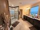 Bathroom featuring a glass-enclosed shower, double vanity sinks, and tile flooring at 12889 Girvan Way, Fishers, IN 46037