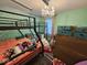 Unique bedroom features bunk beds, a hanging chandelier, and wallpaper with a polka dot pattern at 12889 Girvan Way, Fishers, IN 46037