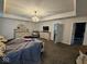 Spacious bedroom featuring a decorative chandelier, dresser with mirror, and access to other rooms at 12889 Girvan Way, Fishers, IN 46037