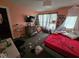 Cozy bedroom with a window view and a modern TV and dresser setup at 12889 Girvan Way, Fishers, IN 46037