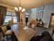 Dining room with a chandelier, large window, and hardwood floors at 12889 Girvan Way, Fishers, IN 46037