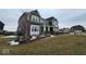 Charming two-story home with brick and siding exterior, covered porch, and well-maintained landscaping at 12889 Girvan Way, Fishers, IN 46037