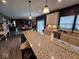 Open concept kitchen with an island, granite countertops, stainless steel appliances, and hardwood floors at 12889 Girvan Way, Fishers, IN 46037