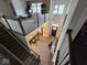 Spacious living area with high ceilings, wooden floors, brick accent wall, and staircase access at 12889 Girvan Way, Fishers, IN 46037