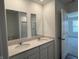 Bathroom boasts double sinks with a light countertop and a shower, creating a functional space at 1414 Bluebonnet Pl, Shelbyville, IN 46176