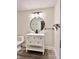 Modern bathroom featuring a vanity with a round mirror and minimalist lighting fixtures at 1427 Broyles Ln, Indianapolis, IN 46231