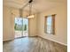 Light-filled dining area featuring a sliding glass door to the backyard and a stylish light fixture at 1427 Broyles Ln, Indianapolis, IN 46231