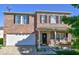 Charming two-story brick home featuring a covered porch with swing and attached two-car garage at 1427 Broyles Ln, Indianapolis, IN 46231