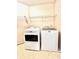 Laundry room with a white Maytag washer and dryer and a wire shelf at 1427 Broyles Ln, Indianapolis, IN 46231