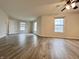 Open-concept living room boasting beautiful wood-look floors and multiple windows providing natural light at 1427 Broyles Ln, Indianapolis, IN 46231