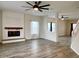 Open concept living room with vinyl floors, fireplace, and stairs to the second floor at 1427 Broyles Ln, Indianapolis, IN 46231