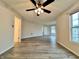 Spacious living room with wood-look flooring, ceiling fan and natural light from the windows at 1427 Broyles Ln, Indianapolis, IN 46231