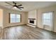 Open living space with modern fireplace, vinyl floors and a stylish ceiling fan at 1427 Broyles Ln, Indianapolis, IN 46231