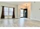 Inviting living room featuring vinyl floors and large windows that let in ample sunlight at 1427 Broyles Ln, Indianapolis, IN 46231