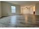 Spacious living room featuring wood-look flooring and a large window for natural light at 1427 Broyles Ln, Indianapolis, IN 46231