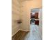 View of the pantry with metal shelves and glimpse into kitchen with stainless steel appliances at 1427 Broyles Ln, Indianapolis, IN 46231